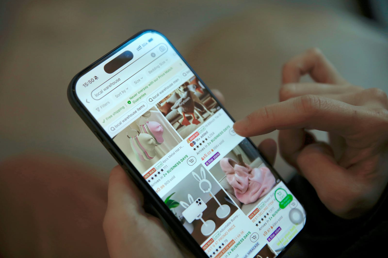 A customer browsing an online store on her phone in the evening